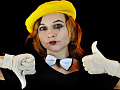 a woman with clown-like makeup making a thumbs up and a thumbs down gesture